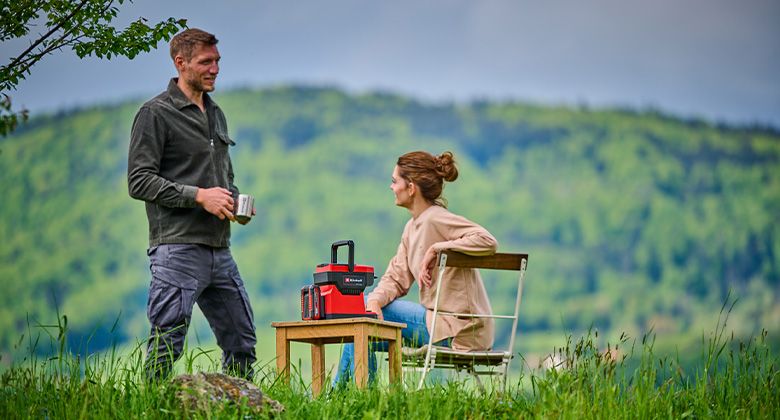 Image of a man and a woman sitting on a meadow