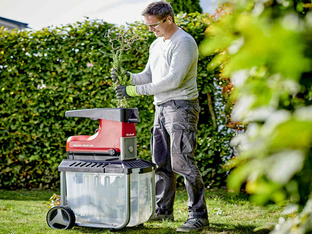 a man chops up bushes