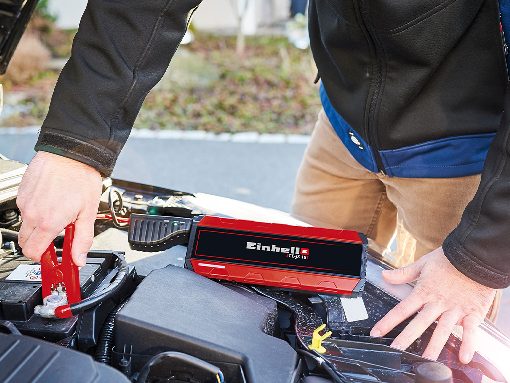 A man charges a car battery